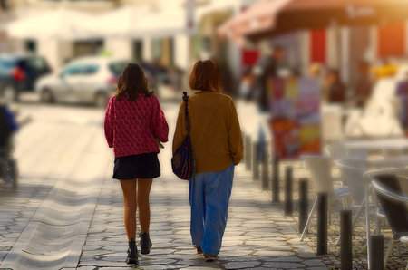 Two women walking through a marketの写真素材
