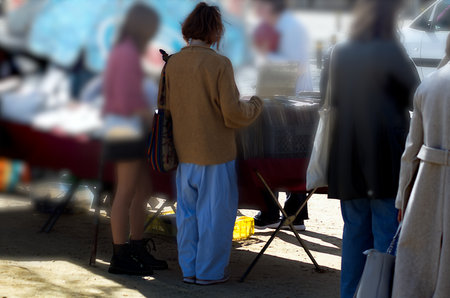 People watching as they walk through a flea marketの写真素材