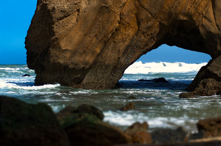Seascape with a rock in the ocean on a windy dayの写真素材