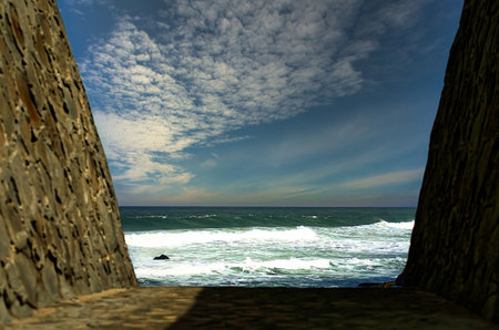 Ocean view from a cobblestone corridorの写真素材