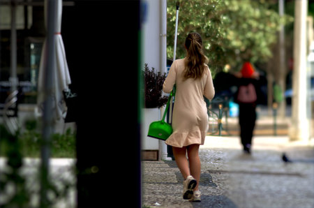 Passersby walking on a street through the cityの写真素材