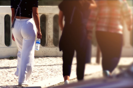 Passersby walking on a street through the cityの写真素材