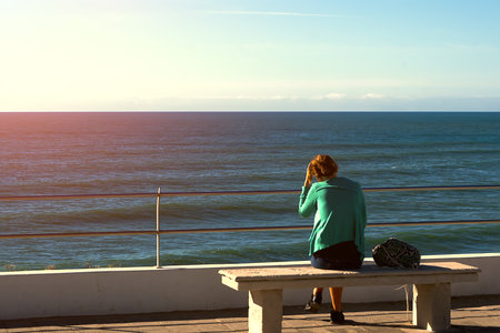 Alone at the seaside admiring the oceanの写真素材