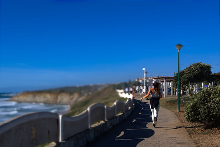 The young woman in white running on the beachの写真素材