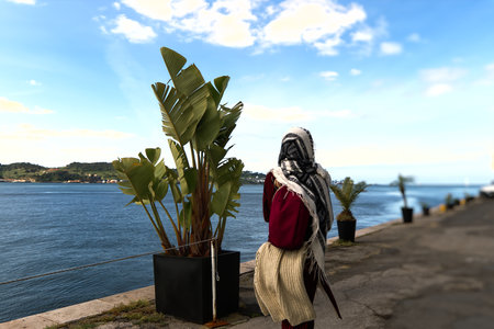 A woman walking in the wind on the pierの写真素材