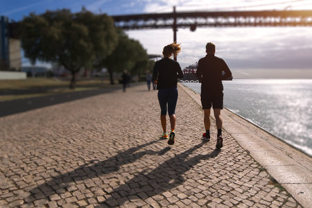 A couple running on the riverbedの写真素材