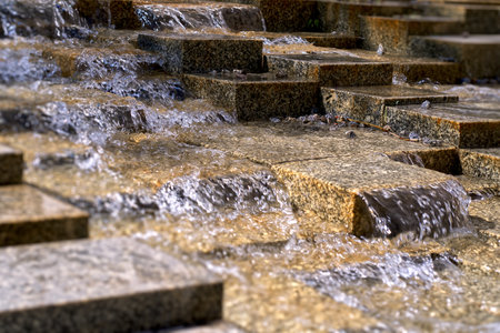 Water flowing on stones in a city settingの写真素材