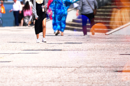 Passersby on a street with a girl in a black dressの写真素材