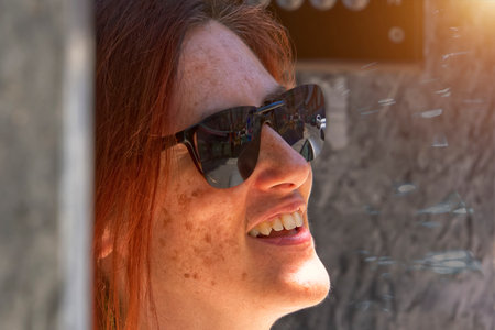 Profile of laughing woman with sunglassesの写真素材