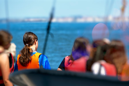 Group of sporty girls rowing on the river bankの写真素材
