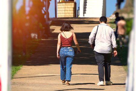 A man with a woman walking in the heatの写真素材