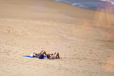 Woman in bikini on the beach tanningの写真素材