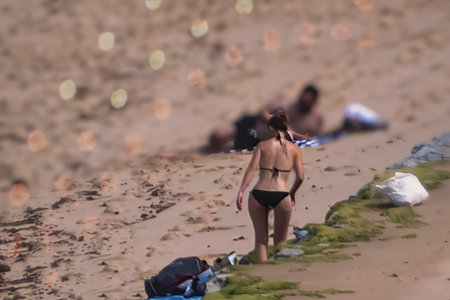Woman in black bikini on the beachの写真素材