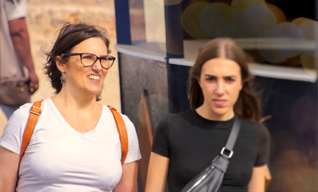 Portrait of a beautiful young woman in the city. Girl with glasses.