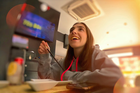 Young woman eating sushi in a fast food restaurant, close-up