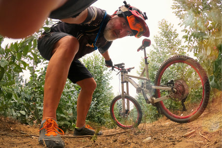 Mountain bike rider in action on forest trail. Extreme sport.