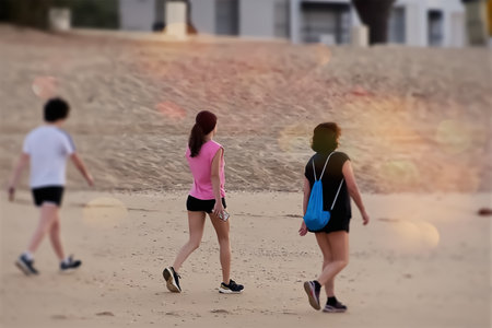 Back view of two people walking on the beach in the evening.の写真素材