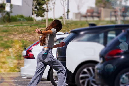 Young woman running on the road with a car in the background.