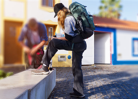 Back view of a young woman with a backpack.の写真素材