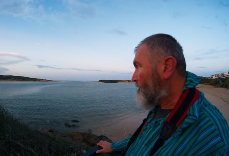 Portrait of an elderly man on the beach in the evening.の写真素材