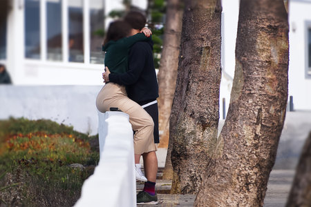 Couple hugging and kissing on the bridge