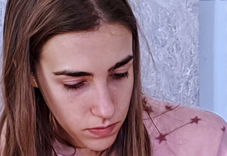 Close up portrait of a sad young woman with tears in her eyesの写真素材