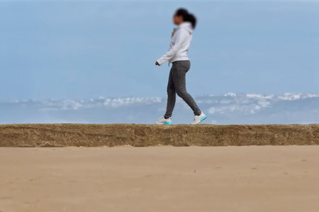 Woman walking on the beach.の写真素材