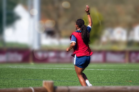 African american female soccer player in action during a soccer game.