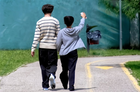 Back view of two boys walking on the pathの写真素材