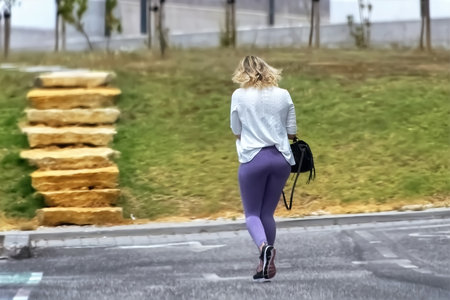 Young woman walking in the city. Healthy lifestyle and fitness concept.の写真素材