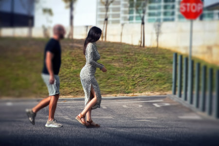 Young couple walking on the street in the city. Back view.の写真素材