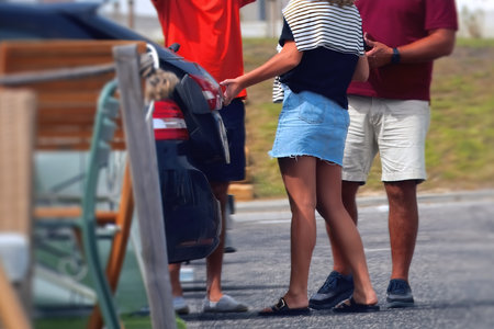 Rear view of a couple holding hands while walking along the street