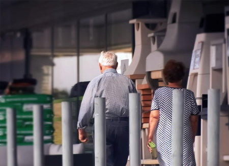 Rear view of a senior man and a woman walking in an airport.の写真素材