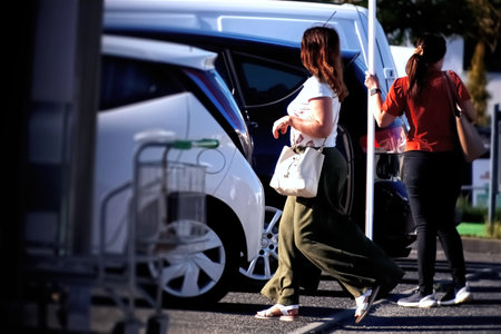 Rear view of a woman walking in front of a white vanの写真素材