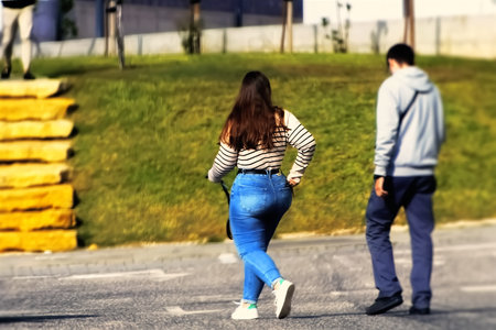 Young couple walking on the street. Back view. Copy space.