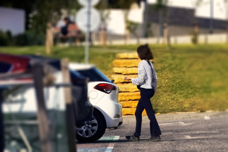 Young woman with a car on the road. Selective focus.