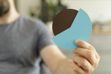 Man Holding a Pie Chart Showing Data Analysis