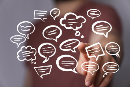 Hand Pointing at Communication Bubbles: Ideas, Chat, Messageの写真素材