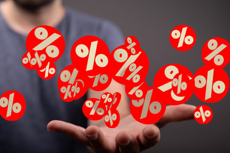 Person Holding Red Percentage Symbols: Discount Offersの写真素材