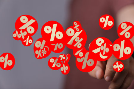 Red Percentage Symbols Hovering Over Handの写真素材
