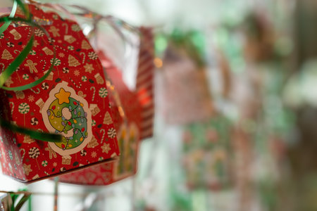 Colorful Christmas ornaments hanging on a tree in a shopの写真素材
