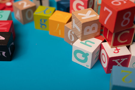 Wooden cubes with letters and numbers on a blue background close upの写真素材