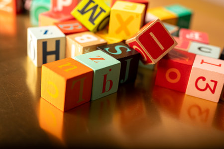 Colorful Alphabet Blocks Scattered on Goldの写真素材