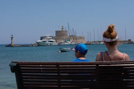 Family enjoying view of Rhodeshore harbor and Mandraki Castle