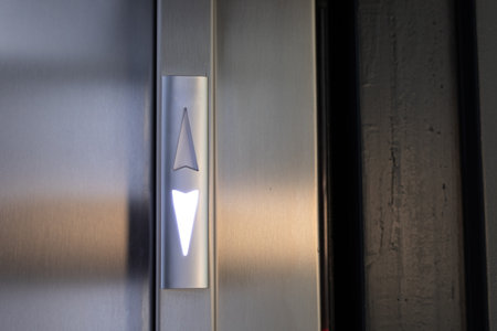 Illuminated Up Arrow on Modern Elevator Panel