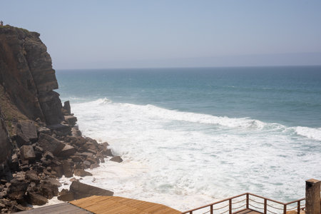 Dramatic Ocean Waves Crashing Against Rugged Cliffsの写真素材