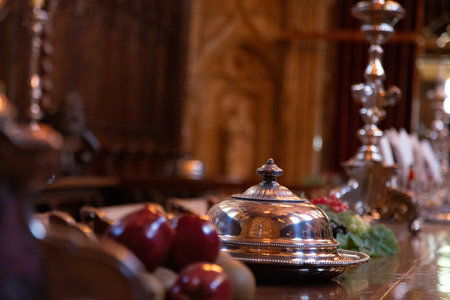 Elegant Silver Cloche with Red Apples on Wooden Table