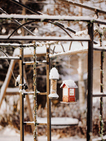 Swedish red bird feeders in the winter. swedish red houses.の写真素材