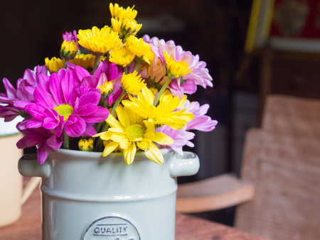 Vase with iron and flowers, vintage style on the table in coffee shops.の写真素材