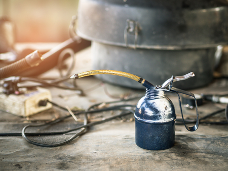 Oil can on wooden table in the garage.の写真素材